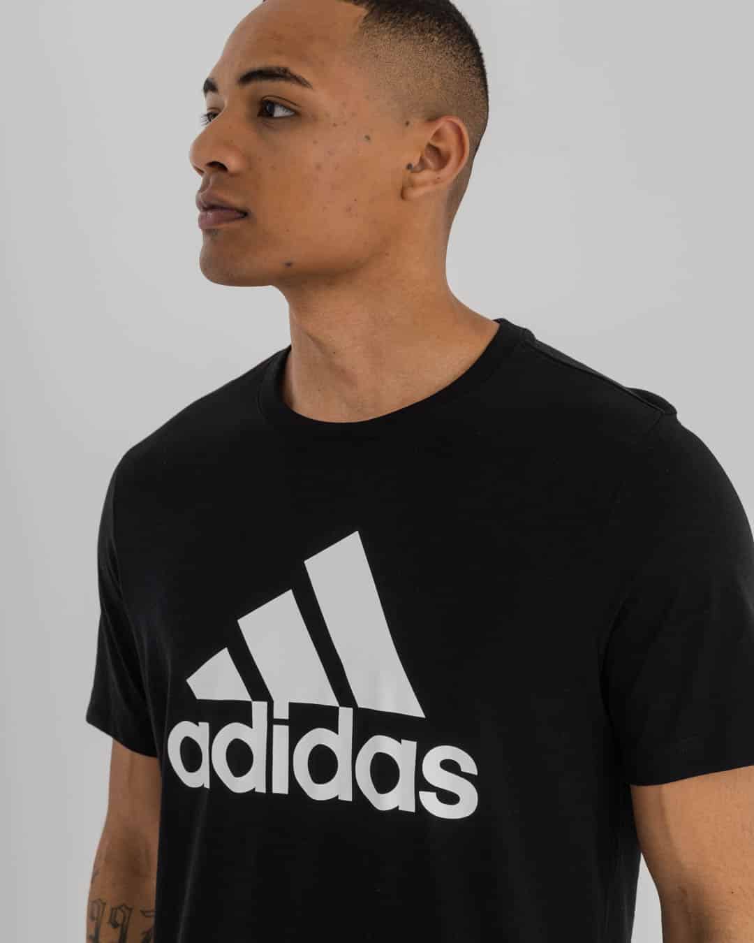 midshot man wearing black Adidas t-shirt Adidas logo on chest