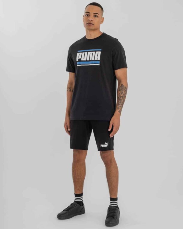 man in black Puma t-shirt and black Puma shorts with Puma logo on bottom right.