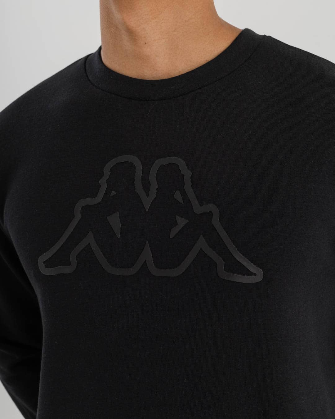 close up of black crew with Kappa logo in black on chest