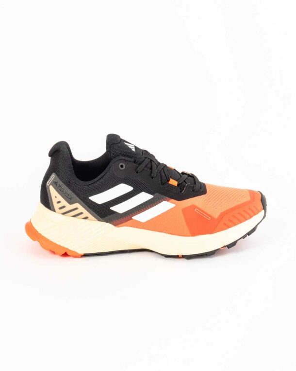 side shot of men's adidas trainers in orange and black paneling with adidas three stripes in white on upper, midsole in cream and crash pad in orange