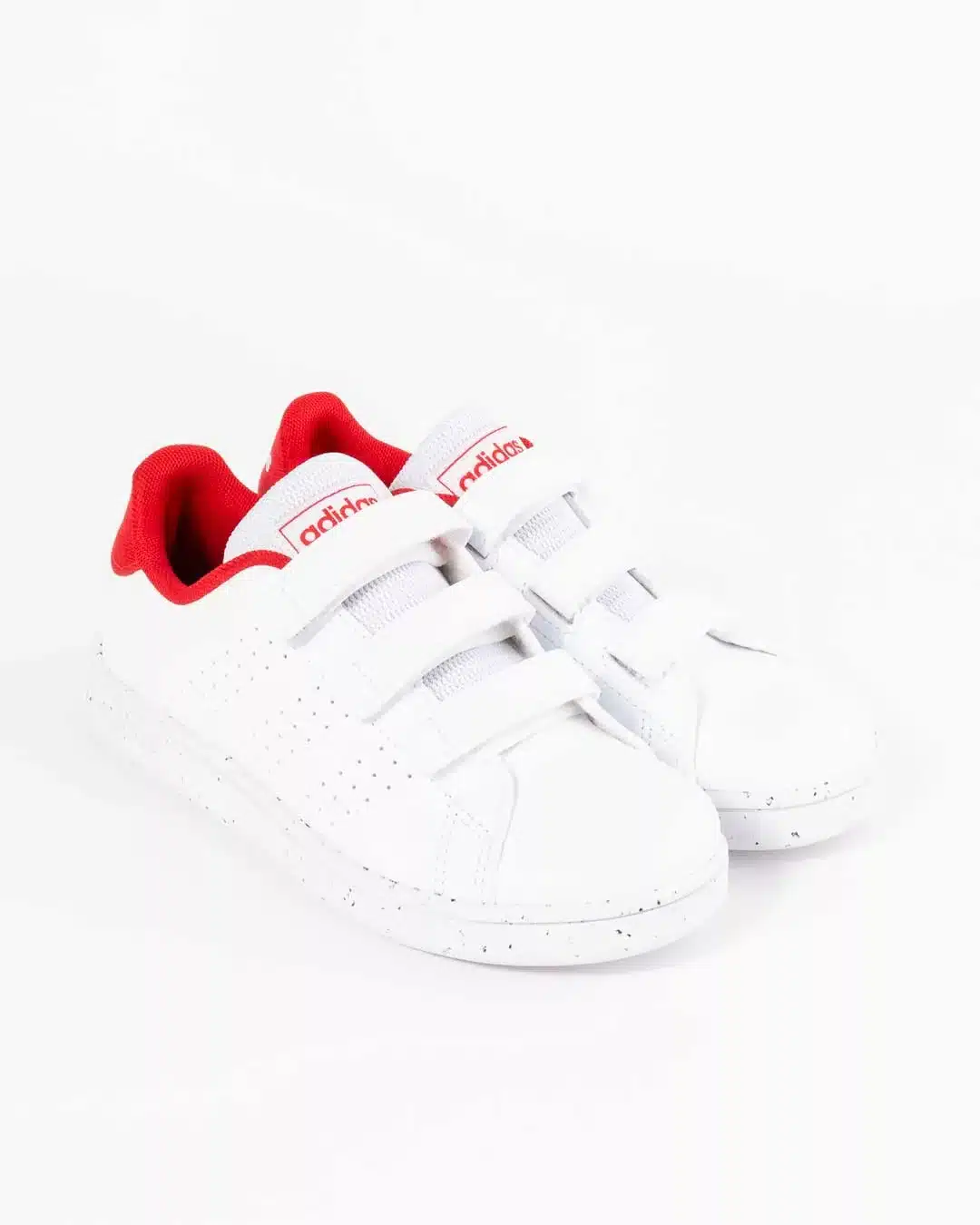 side angled profile of children's white adidas sneaker with red collar and adidas logo on tongue with velcro straps
