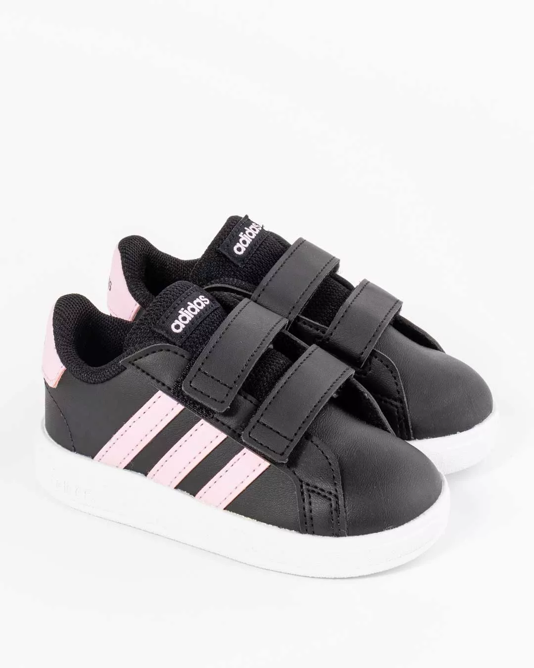 angled side profile of adidas black sneakers with three pink stripes on upper, featuring the adidas logo in pink on tongue ,pink heel counter with adidas logo in black