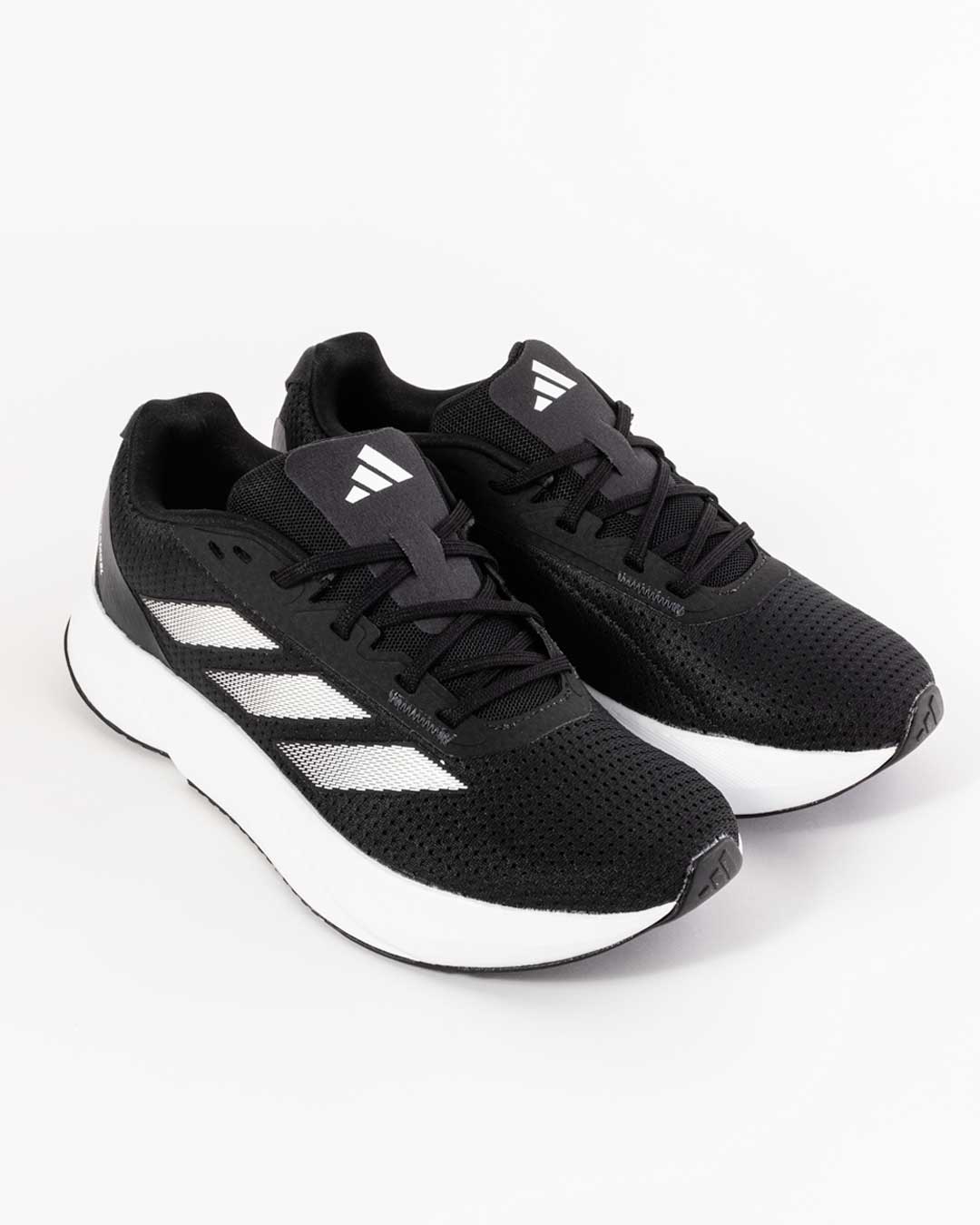aide angled shot of men's adidas trainers in black with three white stripes across upper ,midsole in white and adidas logo on tongue in white. Adidas three stripe logo embossed on toe cap