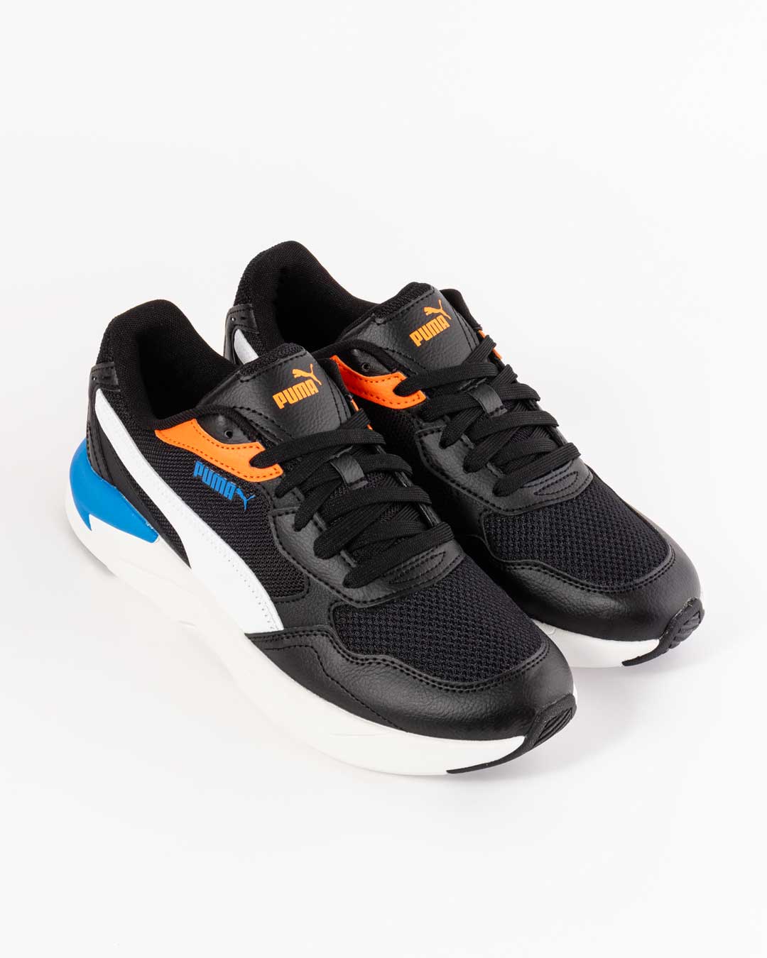 side angled shot of of children's sneakers in black with white , blue and orange paneling, with white midsole. PUMA logo in blue on upper and in orange on tongue
