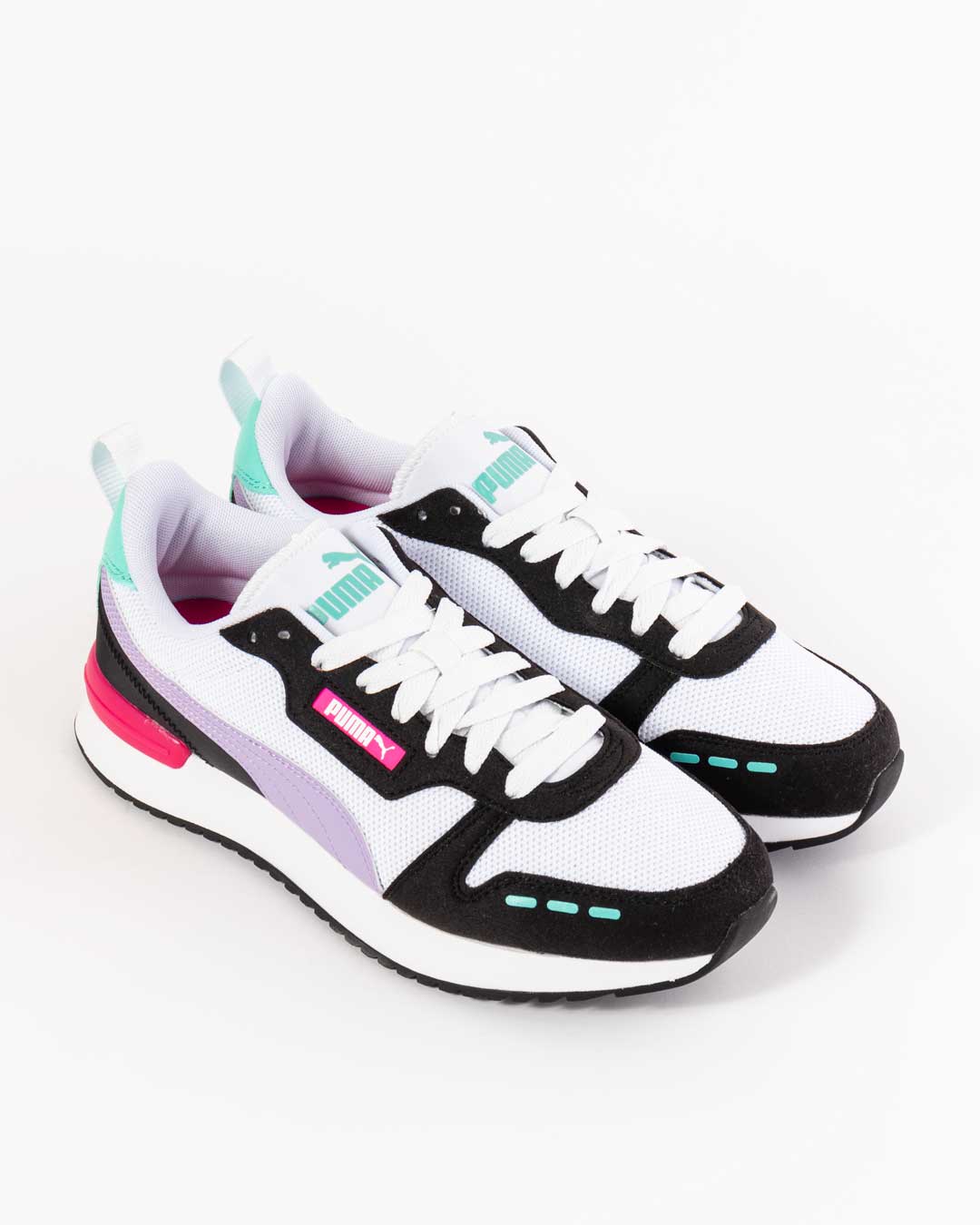 woman's puma sneaker colour blocked paneling in white, green, mint, purple and black with Puma logo underneath eye stay in pink with striped paneling on vamp in mint green