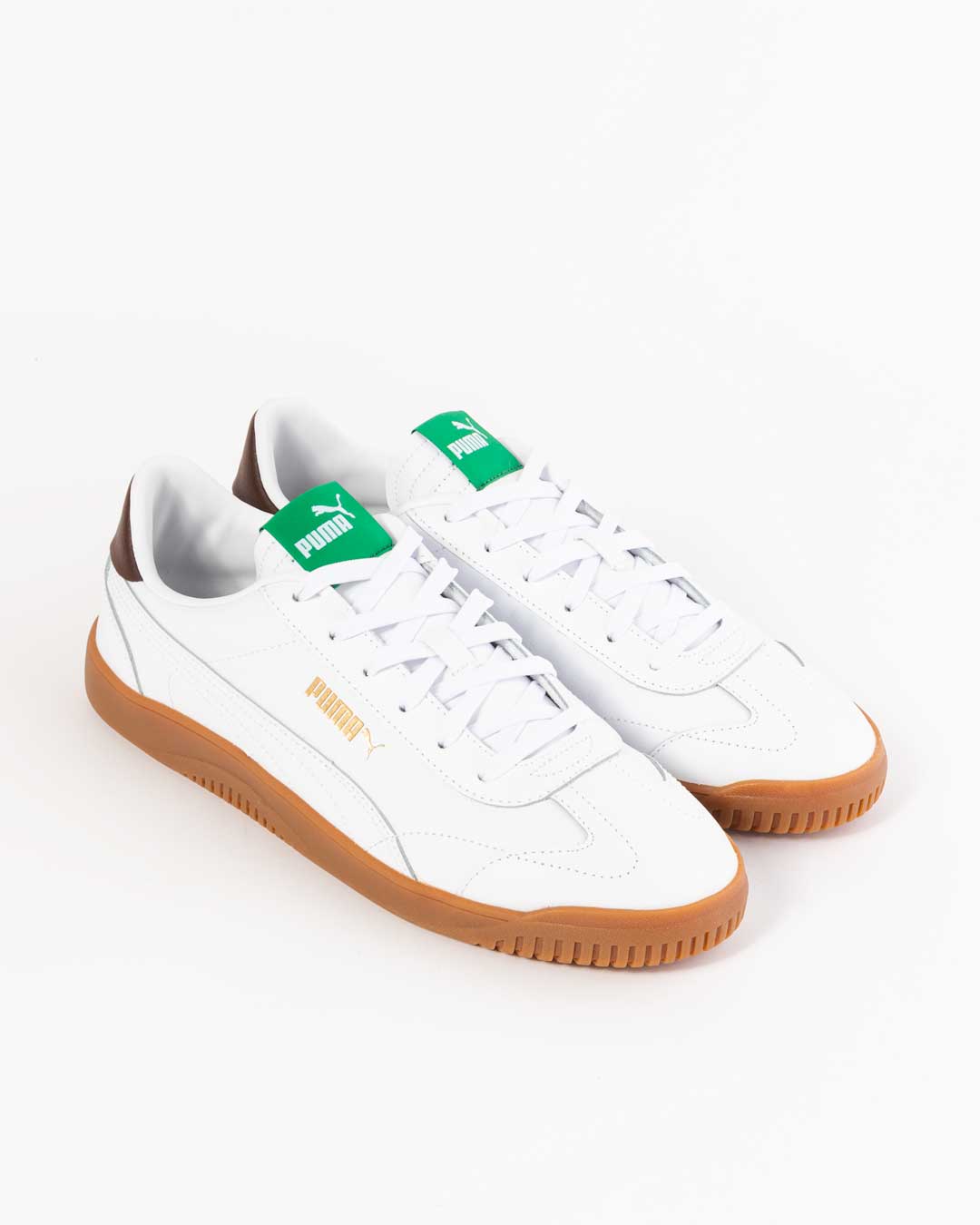 side angled profile of puma men's sneakers in white with gum sole and puma logo in gold. Green paneling on tongue with Puma logo in white